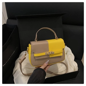 Detailed view of color-block handbag with metal lock in luxury gift box set