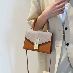 Fashionable brown leather crossbody bag with textured flap and gold metal clasp for women