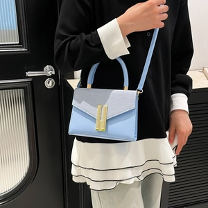 Light blue faux leather crossbody bag with gold H clasp and woven texture panel