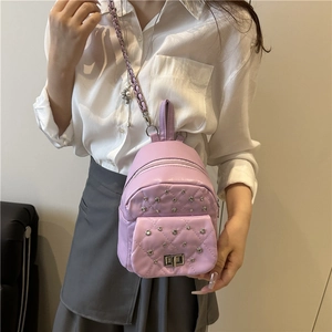 Chic purple quilted backpack with silver studs and chain strap, stylish 2025 mini bag