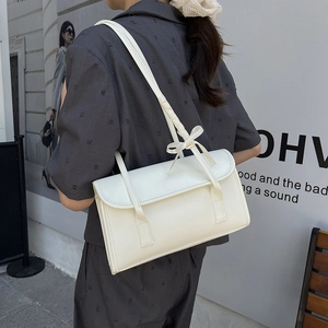Elegant cream white shoulder bag with bow detail and textured leather finish for women