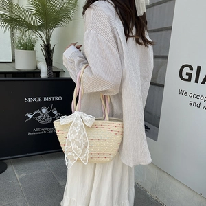 Woven straw handbag with a white lace bow and rope handle for summer casual fashion