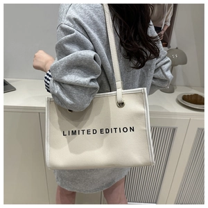 Detail of canvas tote bag featuring LIMITED EDITION print and contrasting trim