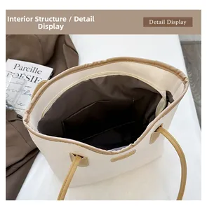 Macro view of white tote bag interior with zipper closure and dark brown lining