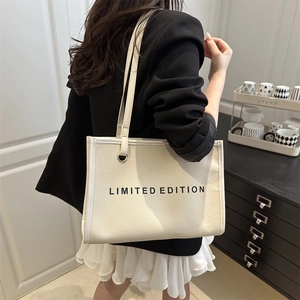 Large off-white canvas tote bag with Limited Edition print for women on black blazer