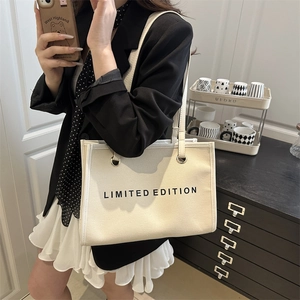 Minimalist off-white canvas tote bag with Limited Edition print for women