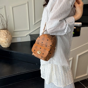 Brown mini backpack with bear and geometric print, gold hardware and top handle design