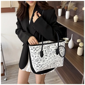 Close-up of white canvas tote bag featuring black doodle art and text graphics for women
