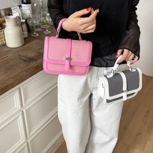 Detailed view of pink and grey woven textured mini handbags with leather trim details