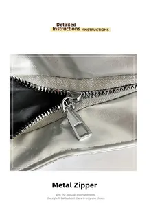 Details von silberner Metallic-Ledertextur und Metallreißverschluss an der Umhängetasche