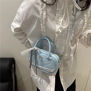 Sweet light blue mini bowling bag with white lace trim and bow charm held by a person