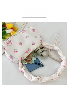 Top view showing the internal storage capacity of the floral pleated shoulder bag