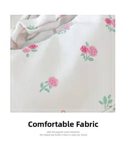 Close-up of comfortable white twill fabric with elegant pink rose floral pattern