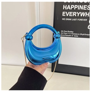 Blue metallic semi-circle handbag with round handle and gold chain strap detail