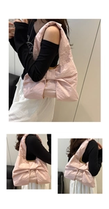 Detailed views of a pink oversized bow shoulder bag with textured nylon fabric
