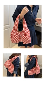 Detail of red and white plaid canvas tote bag with a large decorative 3D bow design