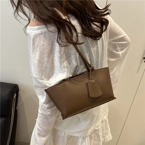 Elegant brown minimalist tote bag for women showing crossbody style and side stitching details