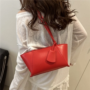 Bright red minimalist tote bag for women featuring a structured trapezoid design and shoulder strap
