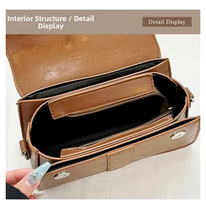 Detail display of brown retro bag interior with multiple compartments and magnetic closure