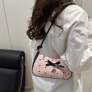 Pink seersucker underarm bag with black bow floral pattern and metal heart pendant
