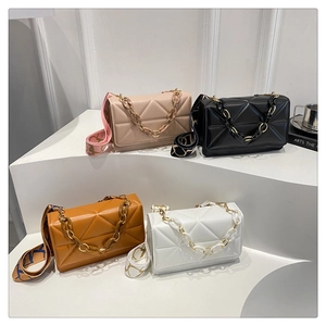 Detailed shot of stylish geometric textured crossbody bags in four elegant colors with wide straps