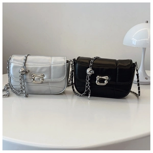 Detail of silver and black quilted mini chain bags with metallic ball adjustment