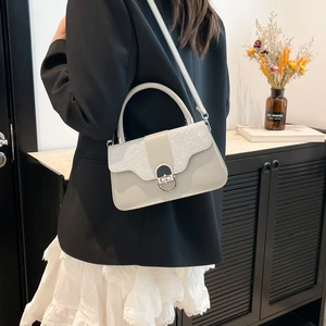 Chic light gray contrast handbag with silver sequins and metal turn-lock on a model