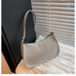Close-up of sparkling silver hobo bag with rhinestone texture and metallic zipper