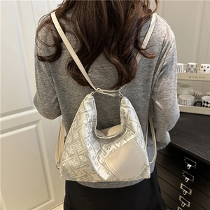 Sac fourre-tout jacquard argenté avec poche en cuir beige porté par un mannequin