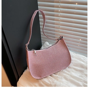 Close-up of pink rhinestone hobo bag with sparkling crystal mesh and metal zipper