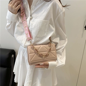 Quilted beige square crossbody bag with decorative chain and jacquard shoulder strap