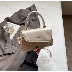Detail of beige leather and woven crossbody bag featuring Fashion & Bags logo print