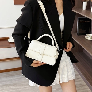 Classic cream leather flap handbag with top handle and adjustable strap for women