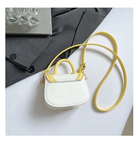 Close-up of a mini white and yellow crossbody bag for girls with high-quality leather texture