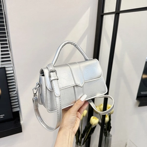 Silver metallic crossbody handbag with glossy crackle texture and adjustable strap