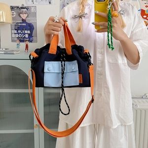 Nylon drawstring bucket bag in navy, orange and blue contrast colors for women
