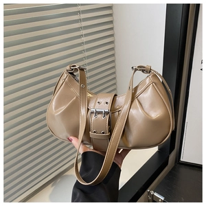 Close-up of khaki glossy PU leather hobo bag with silver eyelets and side pleats