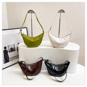 Detailed display of crescent bags in four colors with glossy leather and metal zippers