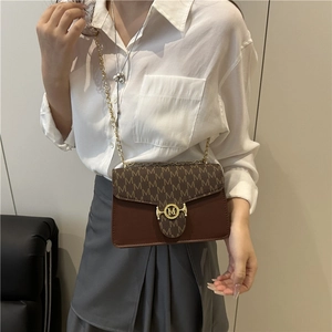 Retro monogram crossbody bag with gold M-logo buckle and chain strap shown on model