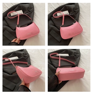 Macro view of pink woven leather texture and hobo shoulder bag stitching details