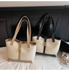 Detail of elegant tote bags in cream, khaki, and black colors with metallic twist locks