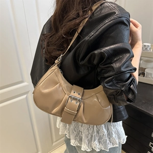Minimalist khaki underarm bag with vintage buckle shown on shoulder for daily wear