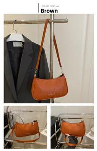 Detail shot of brown woven leather shoulder bag with smooth metal zipper and slim strap