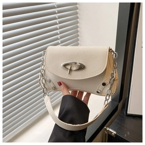 Close-up of cream PU leather shoulder bag with silver buckle and metal chain strap
