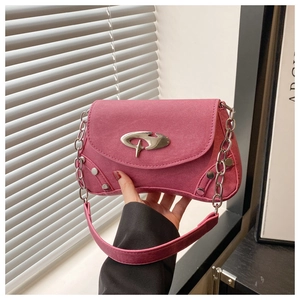 Detail of fuchsia denim bag with silver curved logo, metallic rivets and chain strap