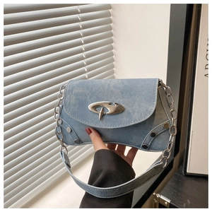 Detail of light blue textured shoulder bag with silver hardware and chain strap