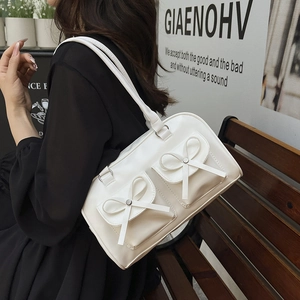 White PU leather ballet-style shoulder bag with cute bow accents on twin front pockets