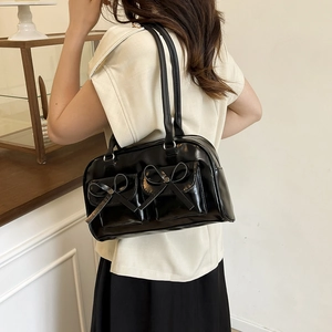 Ballet style black PU leather shoulder bag with chic bow accents and dual flap pockets