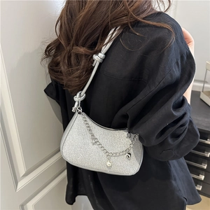 Silver metallic crescent underarm bag with decorative chain and heart pearl charms