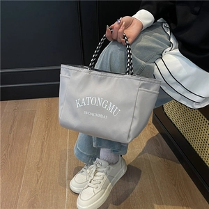 Minimalist grey nylon tote bag with large capacity and stylish woven rope handles